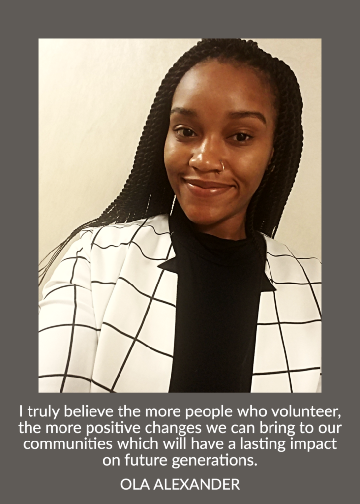 A person with long braided hair, wearing a black shirt and checkered blazer, smiles at the camera. Below is a quote about the importance of volunteering for community impact, attributed to Ola Alexander.