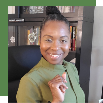 Photo of Stephanie Graham smiling, looking at the camera. There is a bookcase behind her.