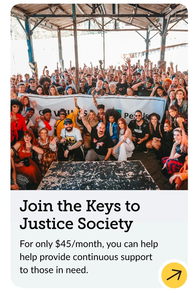 A diverse group of people gathered in a large open space, holding a banner. They are smiling and raising their hands. Below, text reads: "Join the Keys to Justice Society. For only $45/month, you can help provide continuous support to those in need.