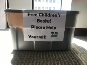 A large gray bin with a sign reading 