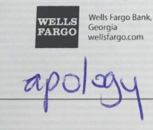 Close-up of a note with the Wells Fargo Bank logo and details, handwritten with the word 