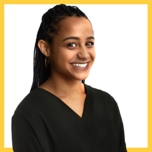 A woman with braided hair and hoop earrings smiles at the camera. She is wearing a black top. The image has a yellow border.