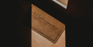 A brown welcome mat with the word 