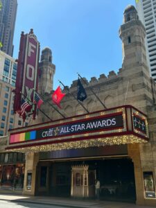 The image shows the exterior of the Fox Theatre with a marquee displaying 