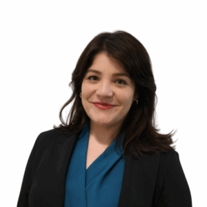 A woman with shoulder-length dark hair, wearing a teal blouse and a black blazer, smiling at the camera against a plain white background.